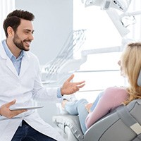 Dentist and patient having friendly conversation