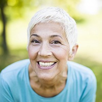 senior woman with implant dentures in Bellingham grinning from ear to ear 