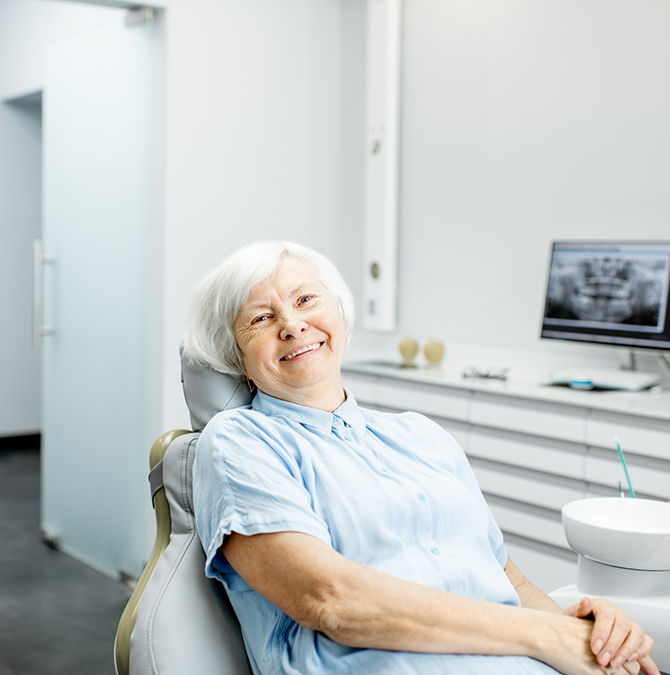 Senior woman grinning in the dental chair