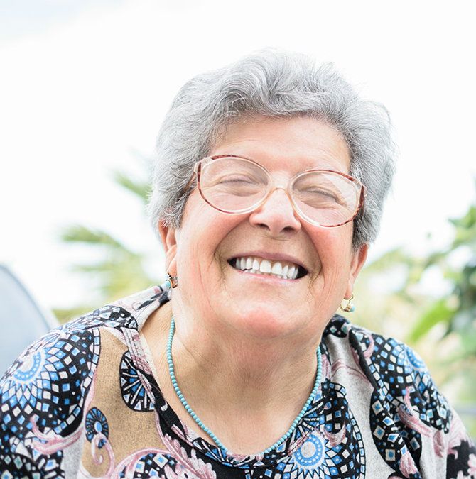 Senior woman grinning outdoors