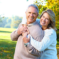 happy elderly couple in a park 