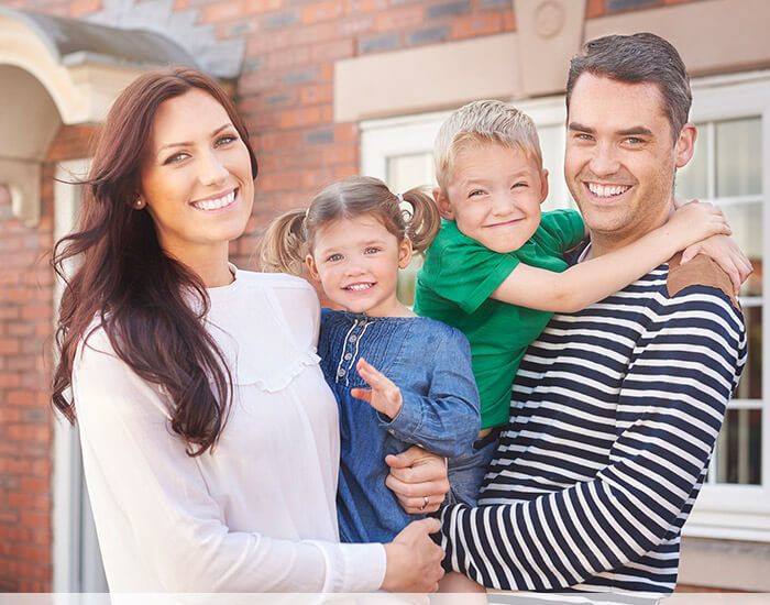 Happy family of four smiling