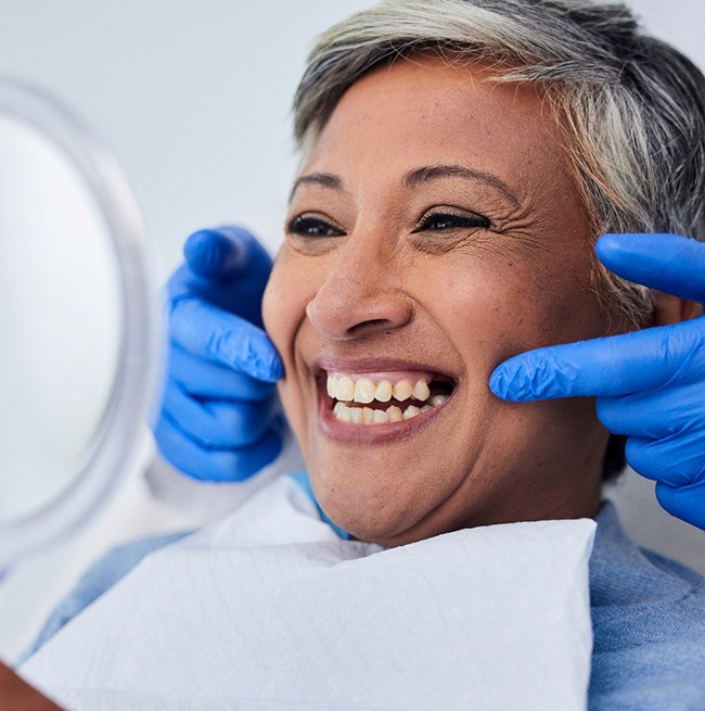 A woman smiling at the dentist