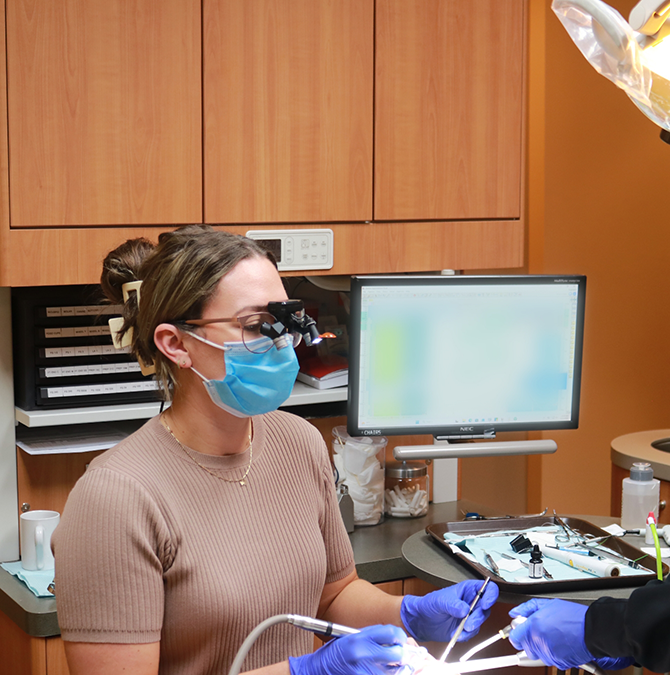 Doctor Montileaux giving a patient a dental exam