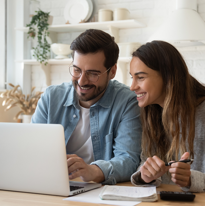 Man and woman looking at a laptop together