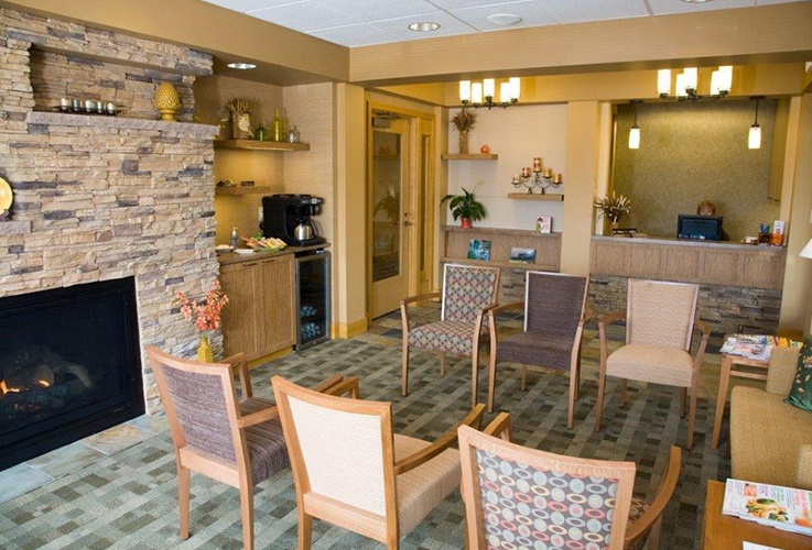Chairs around the fire place in waiting room