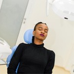 Woman in dental office sitting in chair and relaxing