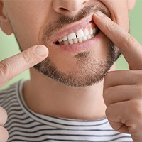 man pointing to inflamed gums