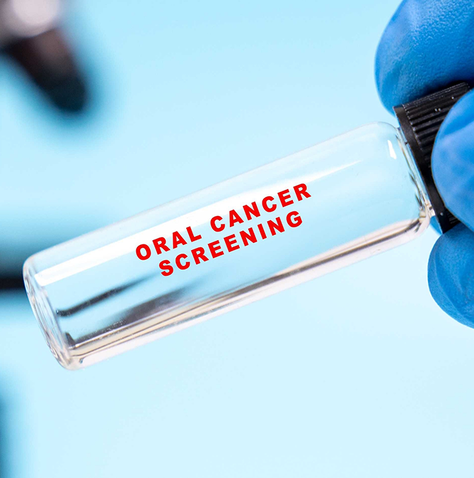 Small empty glass vial labeled oral cancer screening
