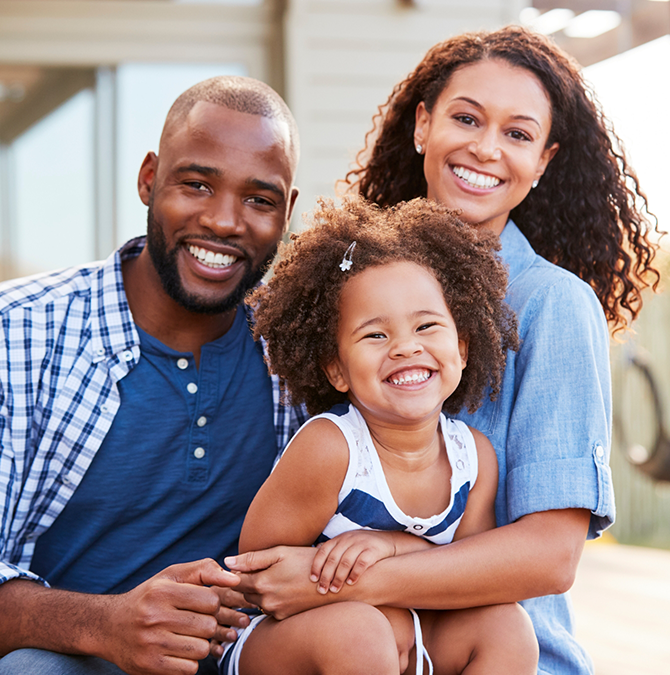 Smiling mother and father with their toddler