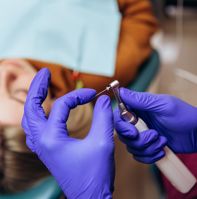 Dentist preparing to perform root canal treatment on a patient