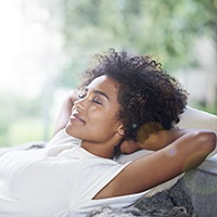 Relaxing woman with hands behind head