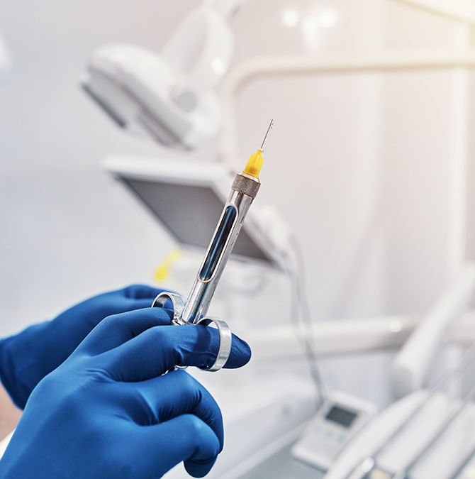 Dentist holding a syringe