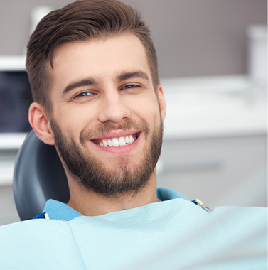 Young man smiling in the dental chair