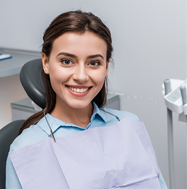 Young woman grinning in the dental chair