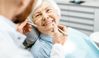 Senior woman grinning at her dentist