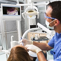 Dentist and patient looking at smile photos