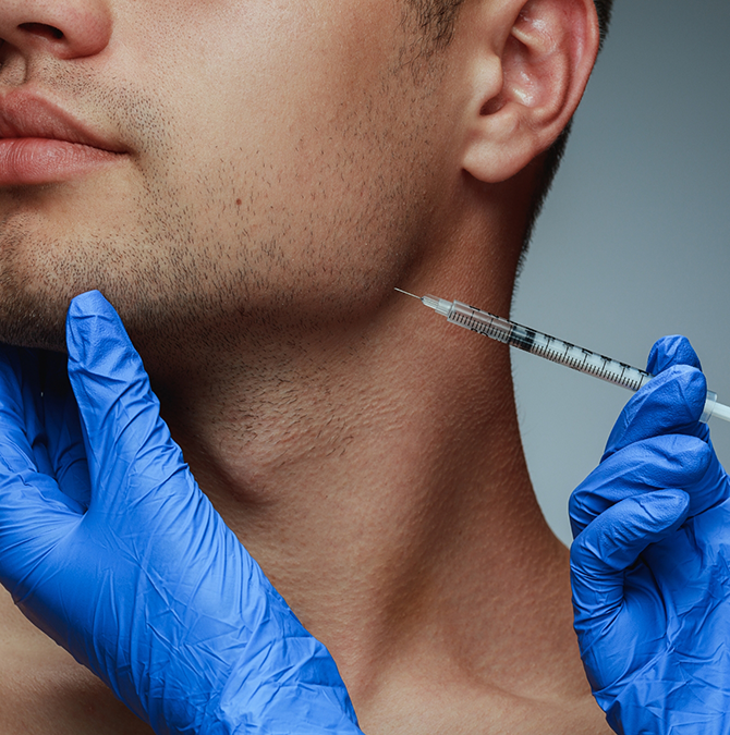 Man receiving an injection near his jaw joint