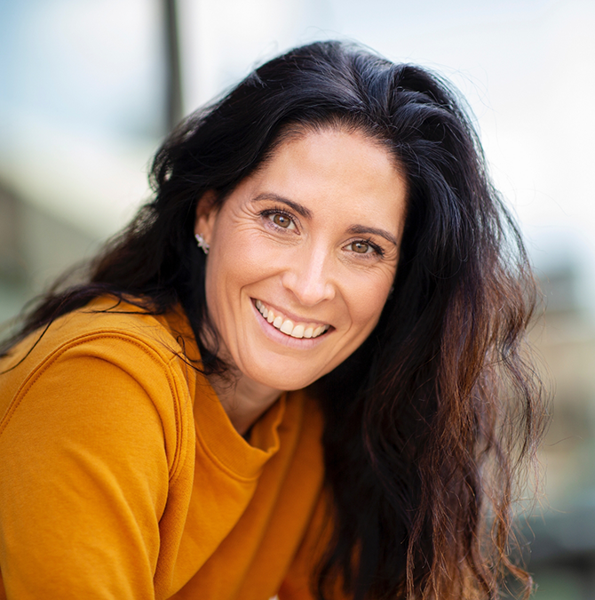 Smiling woman in an orange sweater