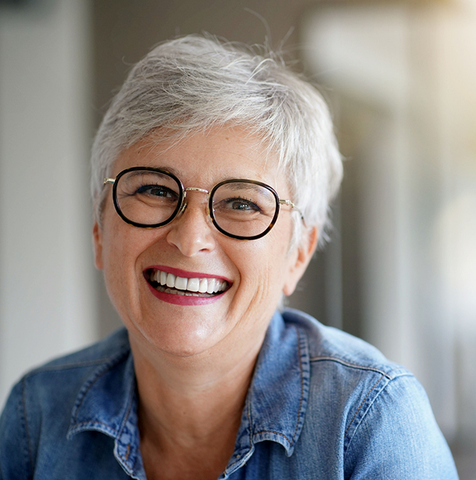 Smiling senior woman in a denim shirt