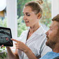 a dentist showing a patient his X-ray