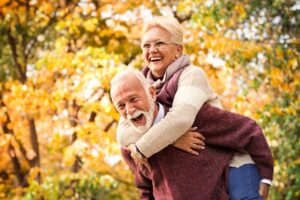 Older couple with dental implant smiling during Thanksgiving