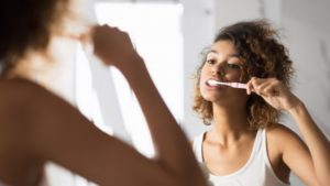 Person brushing teeth with toothbrush from dentist in Bellingham