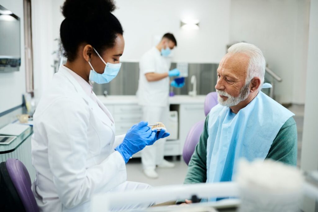 A man having his dentures examined by a dentist