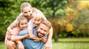 A picture of a family with healthy smiles after seeing a dentist