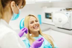 young woman smiling in dentist chair